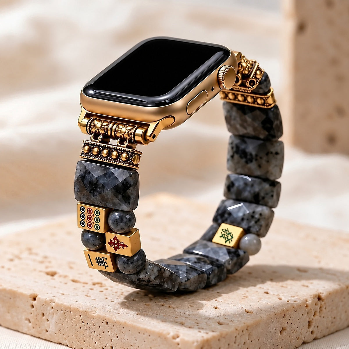 Midnight Fortune labradorite mahjong Apple Watch strap on a gold Apple Watch, standing on travertine